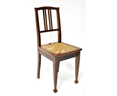 An Edwardian mahogany bergère seated adjustable height chair, on square tapering legs with spade feet, height 90cm.Condition 