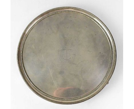 HENRY CHAWNER; a George II hallmarked silver circular salver with beaded rim and an engraved shield-shaped crest with anchor 
