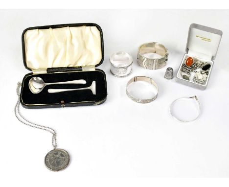 A group of hallmarked silver items, including a Viners child's pusher and spoon, Sheffield 1939, a George V hinged bangle in 