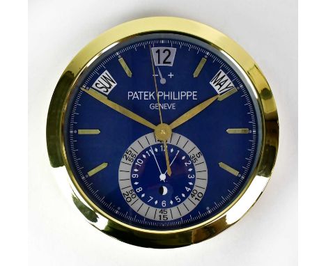 A “Patek Philippe” dealer's display wall clock, with faux subsidiary dials and faux date, day and month apertures, battery op