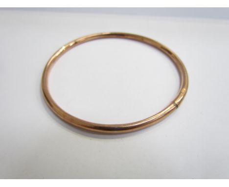 A 9ct rose gold slave bangle, dented, 7.5cm diameter, 7.8g