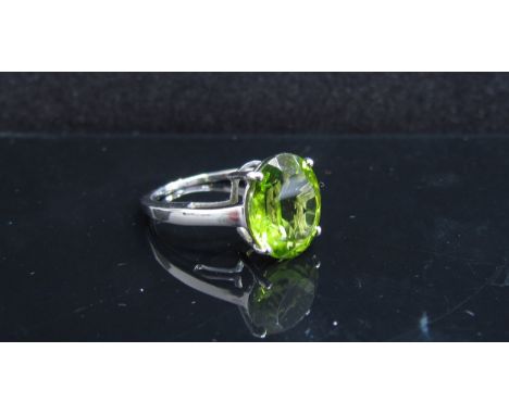 A 9ct white gold changbai peridot ring. Size J/K, 2.4g, with certificate