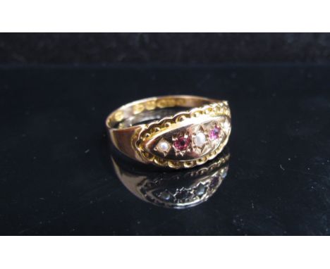 A 15ct gold ruby and seed pearl set ring, stamped Chester. Size M/N, 1.7g