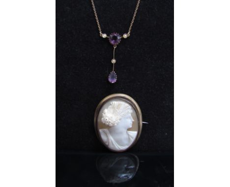 An amethyst coloured stone and pearl drop pendant necklace, unmarked and an oval shell cameo brooch