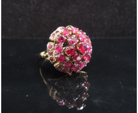 A gold ruby cluster ring in domed setting, stamped 14k. Size L, 5.6g
