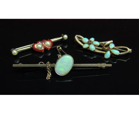 Three gold bar brooches, red enamel heart and pearl, opal and ruby flowers and oval opal examples, 9.7g 