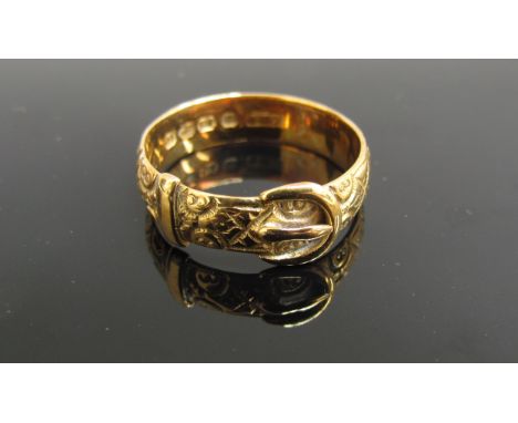 An 18ct gold engraved buckle ring. Size R/S, 5g