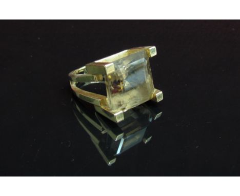 A square cut smoky quartz ring set in high four claw mount and split shank stamped 14k. Size J, 12.1g