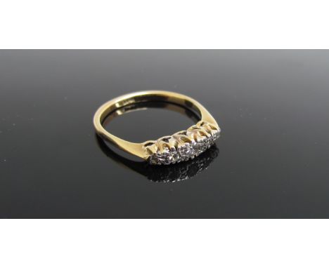 A gold ring with five graduated illusion set diamonds, stamped 18ct. Size N, 2.3g