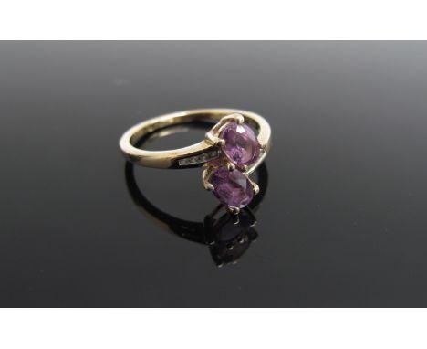 A 9ct gold purple sapphire and diamond ring. Size N/O, 2.4g