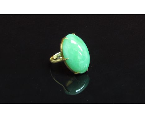 An Oriental gold ring with oval jade cabochon. Size J, 5.1g
