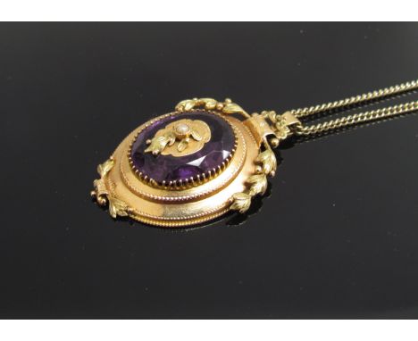 A Victorian gold amethyst coloured pendant set with seed pearls, unmarked on a 9ct gold chain, 9.3g