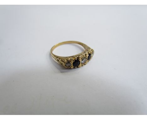 An 18ct gold five stone diamond and sapphire ring in textured mount. Size R, 4.9g