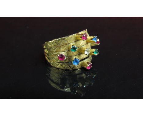 A gold ring with five bands all set with coloured stones. Size O, 4.1g