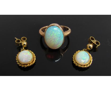 A gold ring set with an oval opal, unmarked. Size K, 3.1g and a pair of opal drop earrings, 2.8g