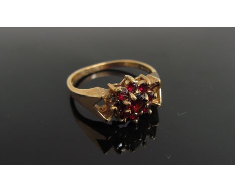 A 9ct gold garnet cluster ring. Size Q, 2.9g