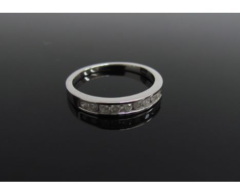 A 9ct white gold half hoop diamond ring. Size N/O, 2.4g