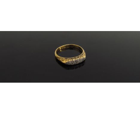 A 22ct gold ring set with five small diamonds, scroll engraved mount. Size N, 3.6g