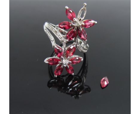 A white gold ruby and diamond dress ring in the form of two flowers (one stone loose). Size Q, 4.1g