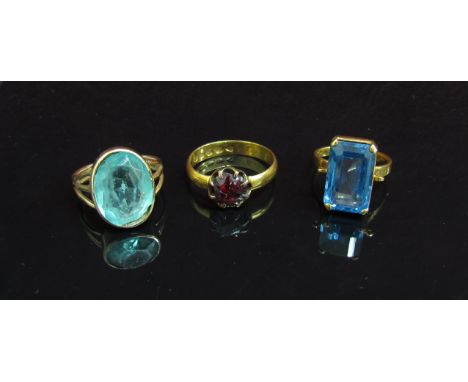 An 22ct gold ring set with garnet (trauma) 4.4g, a blue spinel set ring and another (3) 