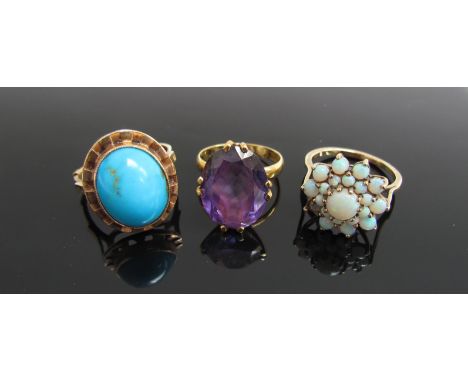 A gold turquoise oval cabochon ring. Size P, an opal cluster ring (one stone missing) Size O and an amethyst coloured claw se