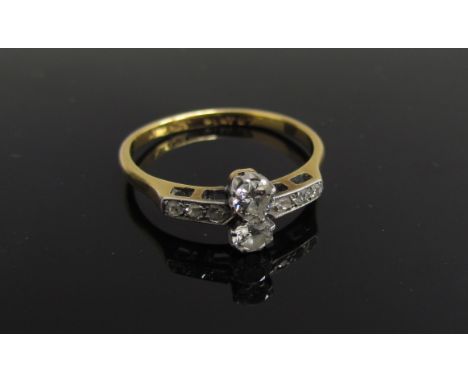 A gold platinum set diamond ring two vertical set diamonds 0.15ct approx each flanked by diamond chips, stamped 18ct plat. Si