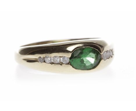 PASTE SET DRESS RINGset with a central oval green paste flanked by two rows of channel set round white gems, foreign hallmark