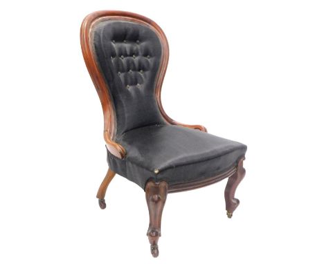 A Victorian mahogany show frame nursing chair, with a black upholstered button back and padded seat, on cabriole legs with ca