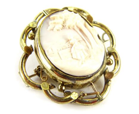 A swivel cameo brooch, the central oval panel depicting lady and tress in village scene, with a portrait back, in gilt metal 