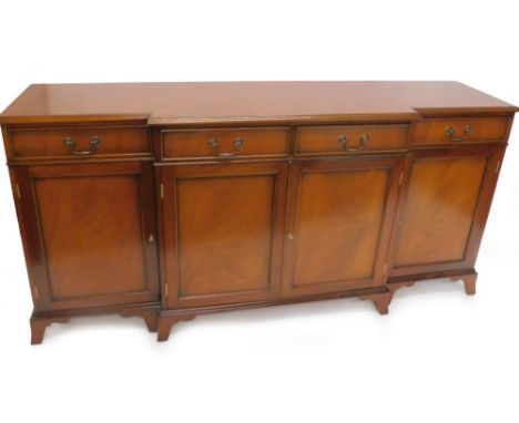 A mahogany breakfront sideboard, with full frieze drawers, with four panelled door on splayed bracket feet, 182cm W.