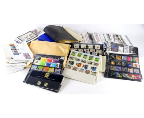 A large quantity of presentation packs, First Day covers, stamps, etc. (2 boxes)