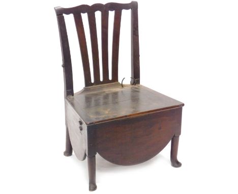 A large 19thC country made oak commode chair, with a pierced splat, the hinged lid enclosing a ceramic bowl on turned taperin