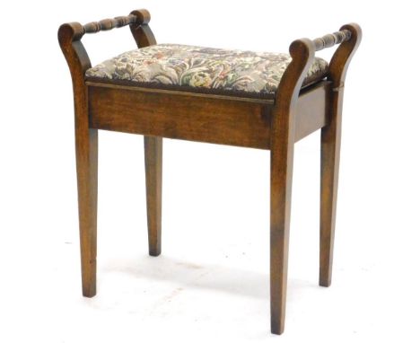 An Edwardian beech piano stool, with a hinged padded seat on square tapering legs.