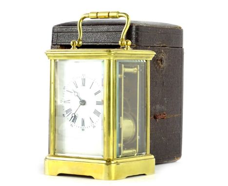 A French brass carriage clock, the enamel dial decorated with Roman numerals, 15cm H in leather travelling case.