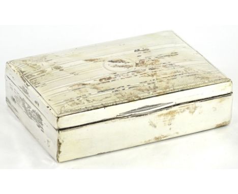 A silver engine turned cigarette box, the hinged lid, with a vacant cartouche, decorated with engine turned bands, enclosing 