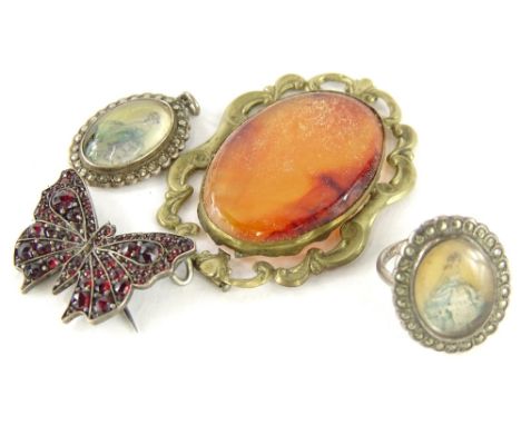 Four items of costume jewellery, to include a silver and marcasite portrait ring, a silver and garnet set butterfly brooch, a