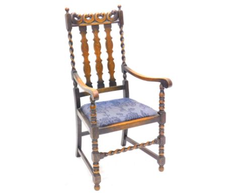 An oak open armchair, the shaped rail back with spirally turned supports, drop in seat, on bobbin turned legs, etc.