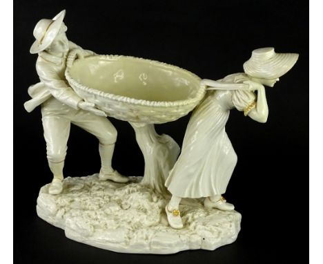 A Royal Worcester Hadley designed centrepiece, modelled in the form of a lady and man holding an oval basket on a branch, imp