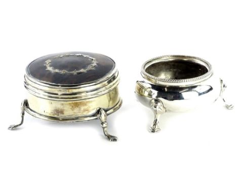 An early 20thC silver tortoiseshell and pique trinket box, the circular hinged lid enclosing a padded interior, and a silver 