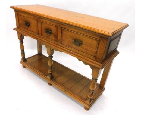 A light oak dresser, the rectangular top with a moulded edge above three frieze drawers, on turned supports with pot board an