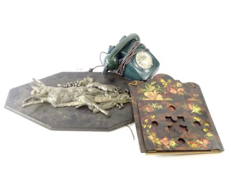 A vintage green plastic telephone, a wall mounted silvered metal plaque depicting dead game, fish etc. and a papier mache let