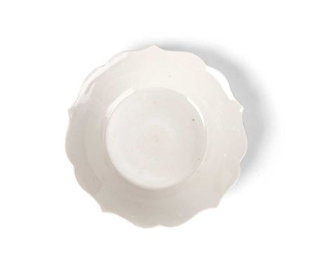 DING-TYPE GLAZED LOBED DISH thinly potted, raised on a flattened ring foot to a foliated rim, covered overall with creamy whi