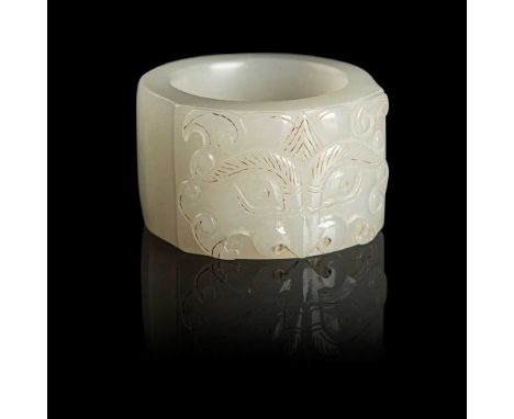 WHITE JADE THUMB RING QING DYNASTY, 19TH CENTURY of cylindrical form, one side of the exterior carved on a slightly raised pa