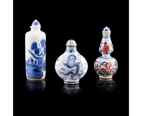GROUP OF THREE SNUFF BOTTLES comprising: one blue and white snuff bottle of cylindrical form painted with natural landscape a