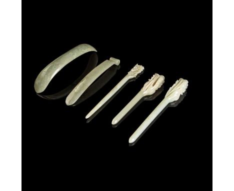 GROUP OF FIVE JADE HAIR ORNAMENTS 19th-20th century comprising: three jade hair pins with one end carved in openwork with flo