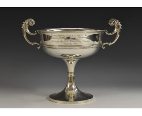 A George V silver shallow pedestal trophy cup, The Dunlop [Golf] Challenge Cup, acanthus-capped flying scroll handles, knoppe