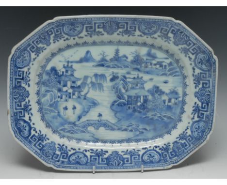 A Chinese canted rectangular meat plate, decorated in tones of underglaze blue with figures in a monumental landscape of pago