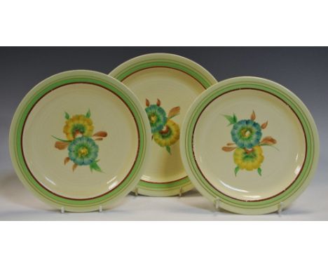 A pair of Clarice Cliff Pansy pattern side plates, 19cm diameter, another dessert plate similar, 21.5cm diameter, the centres