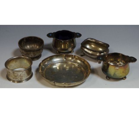 A pair of silver salts, enamelled lug handles'  a silver boat shaped salt;  a silver napkin ring;  a silver pin dish (6)