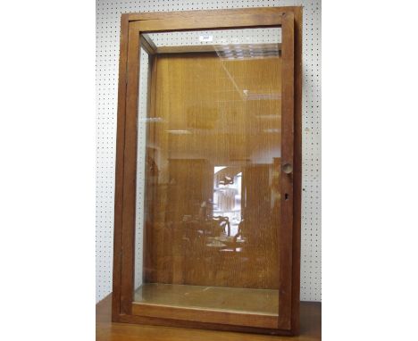 An early/mid 20th centre oak shop counter top display cabinet, glass shelf